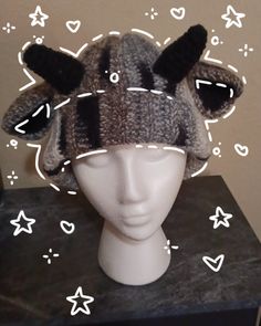 a knitted hat with horns on top of a mannequin's head