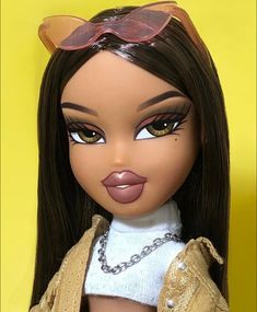 a close up of a doll with sunglasses on her head