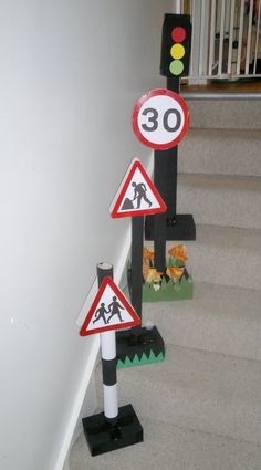 three street signs are placed on the stairs