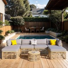 an outdoor living area with a pool and wooden decking