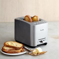 a toaster with two slices of bread and butter on it