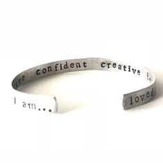 This custom bracelet is hand stamped with your personalized wording. It is a skinnier version of my popular "I am...loved" bracelet.  This little beauty is approximately 1/4 inch wide.Remind yourself (or someone special) how great you really are.This bracelet is stamped with a discreet "I am..." on the bottom of one side, and "loved" on the other.  The inside of the cuff holds up to 5 words of your choice of words.  Customize it your way!The outside of the bracelet has a gently textured finish. Personalized Meaningful Name Bracelet, Adjustable Meaningful Name Bracelet For Best Friend, Meaningful Adjustable Name Bracelet For Best Friend, Personalized Inspirational Cuff Bracelet For Everyday, Minimalist Hand Stamped Name Bracelet For Friendship, Personalized Silver Minimalist Wristband, Customizable Meaningful Bracelets For Everyday, Meaningful Personalized Bangle Bracelet, Personalized Minimalist Silver Wristband