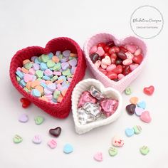 two heart shaped baskets filled with candy hearts