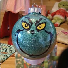 a green ornament with an angry face painted on it