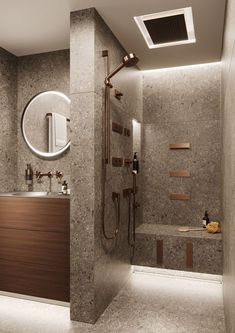 a bathroom with a sink, mirror and shower head in it's center wall