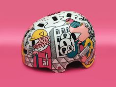 a helmet is shown on a pink background with an image of people and animals painted on it