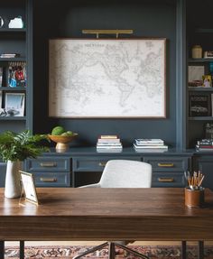 a desk with a map on the wall and a video play button in front of it