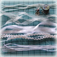 some white ribbons and beads on a table