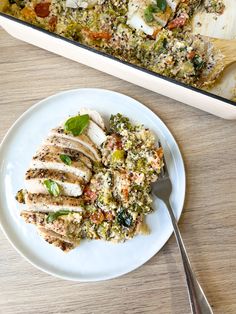 a white plate topped with food next to a casserole dish filled with chicken