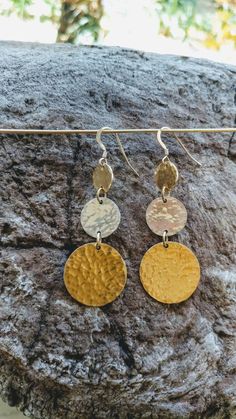 These long hammered circle earrings are made from high quality gold fill and sterling silver disks. They are hand hammered to give a beautiful texture and to catch the light for a radiant shine. They hang from small gold fill french ear wires which are completely hypoallergenic. They are simple and elegant and look great with a dress, evening gown or jeans and a t-shirt. They will be your new favorite earrings! Also available in sterling silver with gold center, all gold and all silver. Please m Hammered Round Disc Metal Jewelry, Hammered Metal Round Disc Jewelry, Hammered Metal Round Earrings, Nickel-free Round Metal Linear Earrings, Nickel-free Metal Linear Earrings, Gold Hammered Circle Earrings, Hammered Brass Round Disc Earrings, Gold Hammered Metal Linear Earrings, Silver Earrings Long