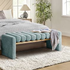 a bed that has been made and is sitting on a rug