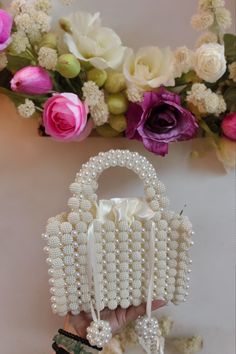 Introducing the Elegant White Beaded Handbag, a timeless chic accessory perfect for any occasion. This exquisite handbag features intricate beadwork, showcasing a stunning design that effortlessly combines elegance and sophistication. The pristine white beads glisten beautifully, making this bag a standout piece in your collection. Ideal for both day and evening wear, the Elegant White Beaded Handbag is spacious enough to hold your essentials while maintaining a sleek and refined look. Whether y White Pearl Evening Bag For Party, White Evening Bag With Pearl Embroidery For Party, White Evening Bag With Pearl Handle For Party, White Handheld Bag With Pearl Handle, White Handheld Shoulder Bag With Pearl Handle, Formal White Bags With Pearl Handle, White Beaded Handheld Evening Bag, White Beaded Bag For Gift, White Pearl Party Bags