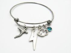 Hand crafted and personalized with love, this storm chaser inspired expandable bangle bracelet features lead/nickel free: antiqued silver tone Lightning bolt charm, Cloud charm and pewter Tornado charm with genuine Swarovski birthstone crystal on an adjustable stainless steel bangle bracelet. Bracelet measures 60/65mm in diameter and fits 6-8.5 inch wrist size. Please note you will need to expand this bracelet over your hand. This bracelet is Ready to Ship. CHOOSE your birthstone crystal at chec Tornado Clouds, Storm Chaser, Expandable Bangle Bracelet, Stainless Steel Bangles, Adjustable Bangle, Letter Charms, Lightning Bolt, Tornado, Bangle Bracelet