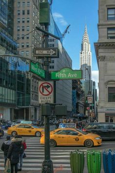 the street signs are clearly visible for all of us to see on this busy city street