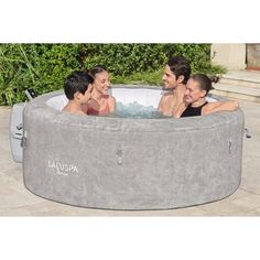 three people sitting in an outdoor hot tub with their backs turned to the side and laughing