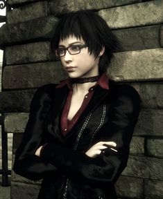 a woman with glasses standing in front of a brick wall wearing a black suit and red shirt