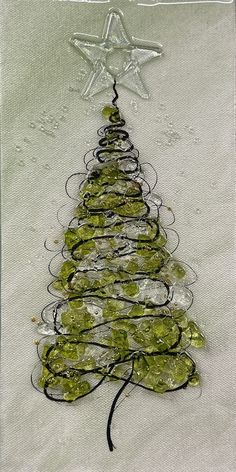 a christmas tree made out of rocks and wire