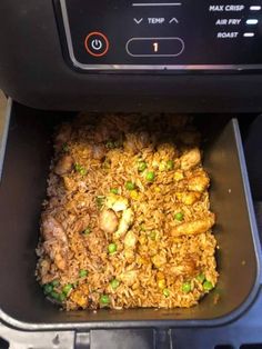 an air fryer with rice and meat in it