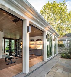 an outdoor gym area with sliding glass doors leading to the back yard and outside kitchen