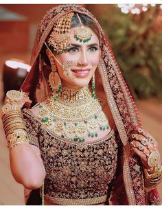 a woman in a bridal outfit posing for the camera