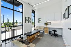 an office with lots of windows and furniture