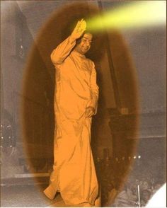 an image of a man that is standing in front of a light emitting from his hand