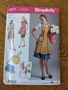 a woman's apron and dress sewing pattern on a table