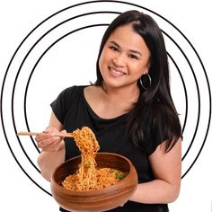 a woman holding a bowl of noodles with chopsticks in her hand and smiling at the camera