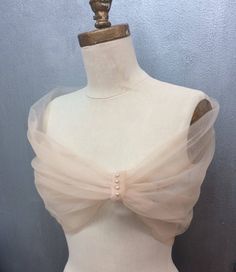 a mannequin wearing a white dress with a bow on it's back