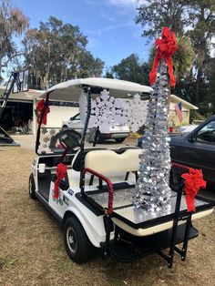 a golf cart decorated with silver and red bows