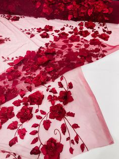 two pieces of red fabric with flowers on them