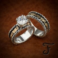 two wedding rings sitting on top of a table