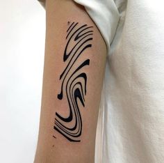 a person with a tattoo on their arm that has wavy lines in black and white