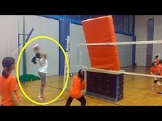 two girls playing volleyball in an indoor gym