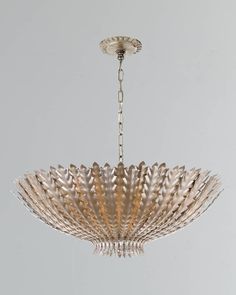 a chandelier hanging from the ceiling in a room with white walls and flooring