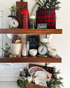 the shelves are filled with dishes and christmas decorations