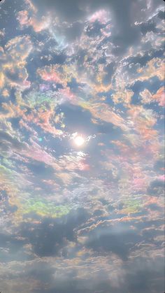 the sky is filled with colorful clouds as the sun shines brightly in the distance