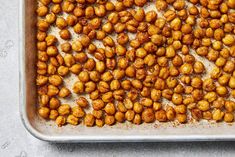 roasted chickpeas on a baking sheet ready to go into the oven for roasting