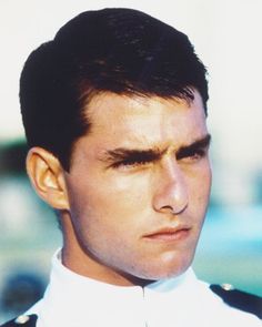 a close up of a person wearing a uniform and looking off to the side with a serious look on his face