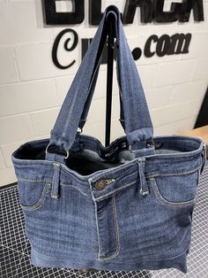 a blue jean purse sitting on top of a table