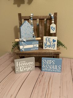 three wooden signs sitting on top of a wooden table