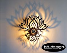 a wall light with a flower design on it