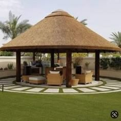 a gazebo with chairs and tables in the middle of a lawn area next to palm trees