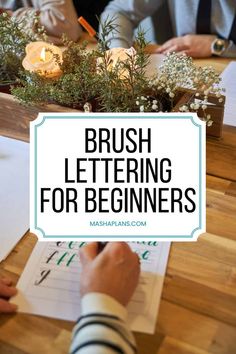 the words brush lettering for beginners are displayed over a wooden table with people working on paper