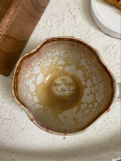 a brown and white bowl sitting on top of a counter