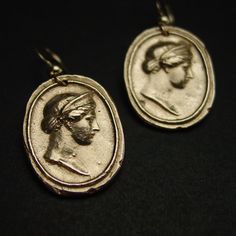 Handmade intaglio reproduction showing the birthing goddess Hera. Hera was a powerful goddess, the wife and sister of Zeus. She was worshiped as the Queen of Heaven as well as the Goddess of Marriage, Women and Birth. Roman equivalent Juno. - Handmade cameos - Solid yellow bronze also called jeweler gold bronze cameos. - 14k gold filled ear wire. - Gold filled has 100 times more gold than plated so does not rub or peel off. - Nickel free. - Reproduction of a 17th c. Victorian cameo. - Signed in Brass Medallion Earrings For Pierced Ears, Elegant Hand Cast Drop Earrings, Elegant Hand Cast Brass Earrings, Handmade Yellow Gold Plug Earrings, Symbolic Bronze Drop Earrings, Brass Medallion Earrings As A Gift, Handmade Symbolic Yellow Gold Earrings, Elegant Medallion Earrings For Gift, Symbolic Round Earrings