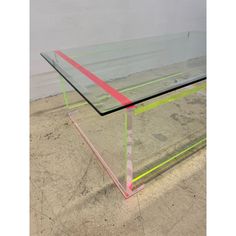 a glass table sitting on top of a sandy ground