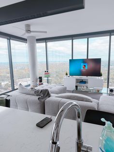 a living room filled with furniture and a flat screen tv on top of a wall