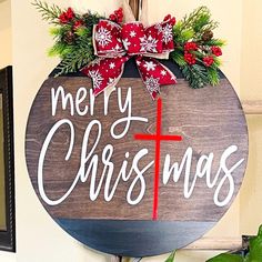 a merry christmas sign hanging on the wall