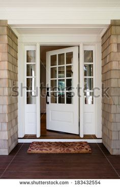 the front door is open and there are two glass doors